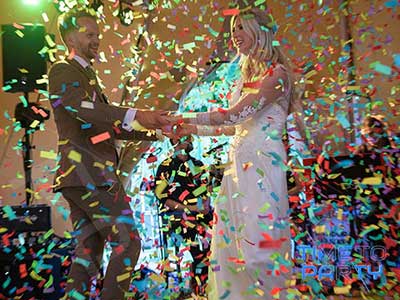 Bride And Groom Dancing In Confetti