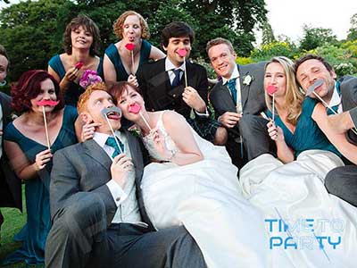 Wedding Guests Enjoying Photo Booth Props